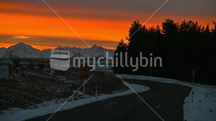 Road to snow mountains in sunset